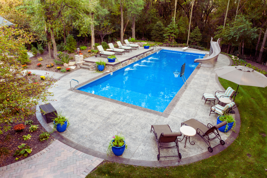 private swimming pool with concrete pool deck